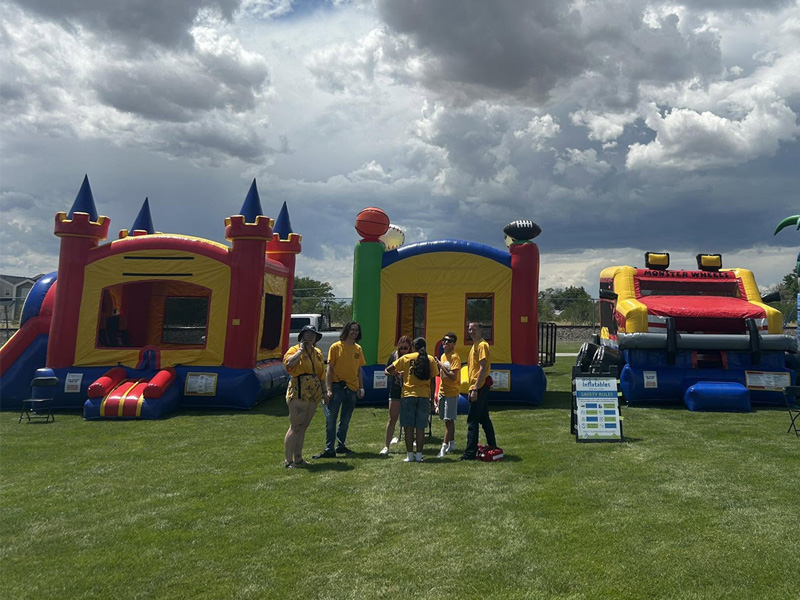 group of workers standing in front of bounce houses